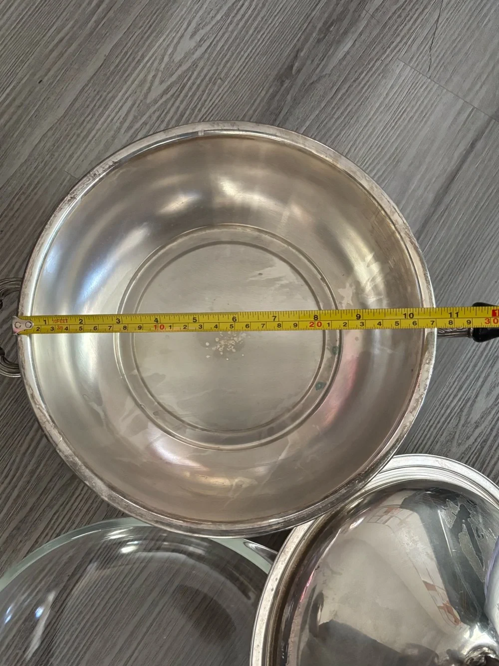 Pyrex glass insert inside a covered silver-plated pot with lid. Used